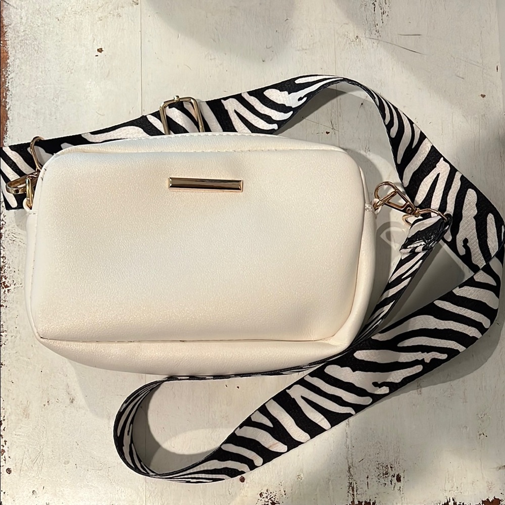 Stylish White Crossbody Bag with Zebra Strap